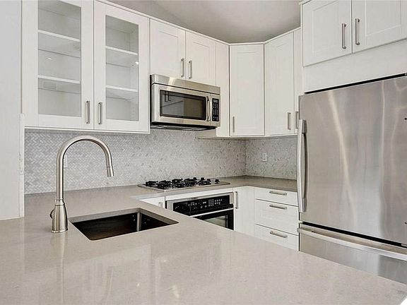 New cabinetry, microwave, stovetop/ oven, refrigerator.