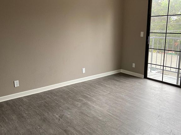 Bedroom with balcony and ceiling fan