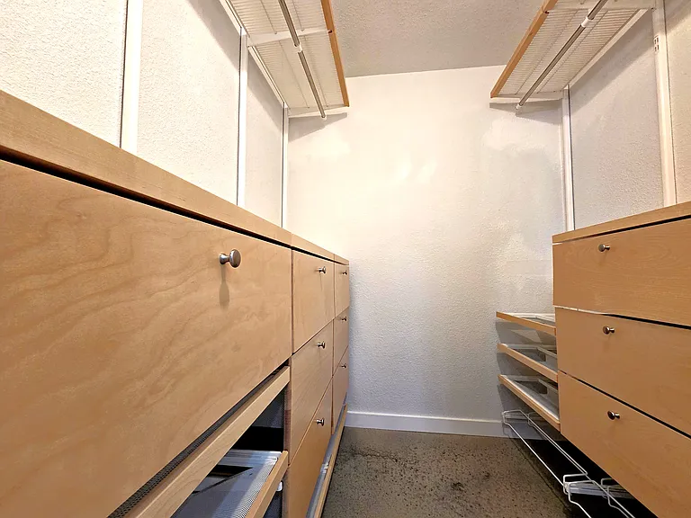 Master Closet with modern storage drawers and racks