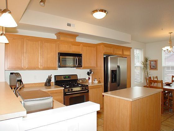 Open kitchen shines with stainless steel appliances