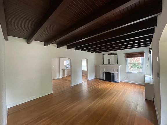 Living room with nonfunctional fireplace.