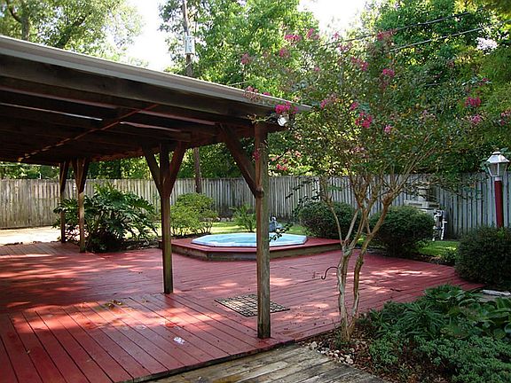 COVERED PATIO WITH PLENTY OF SHADE TREES.