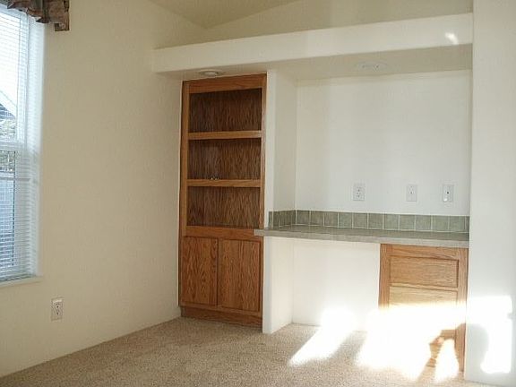 Den/Office area with built-in, entry through glass french doors