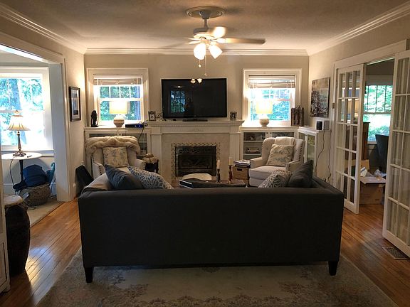 Spacious living room with custom built ins and gas fireplace