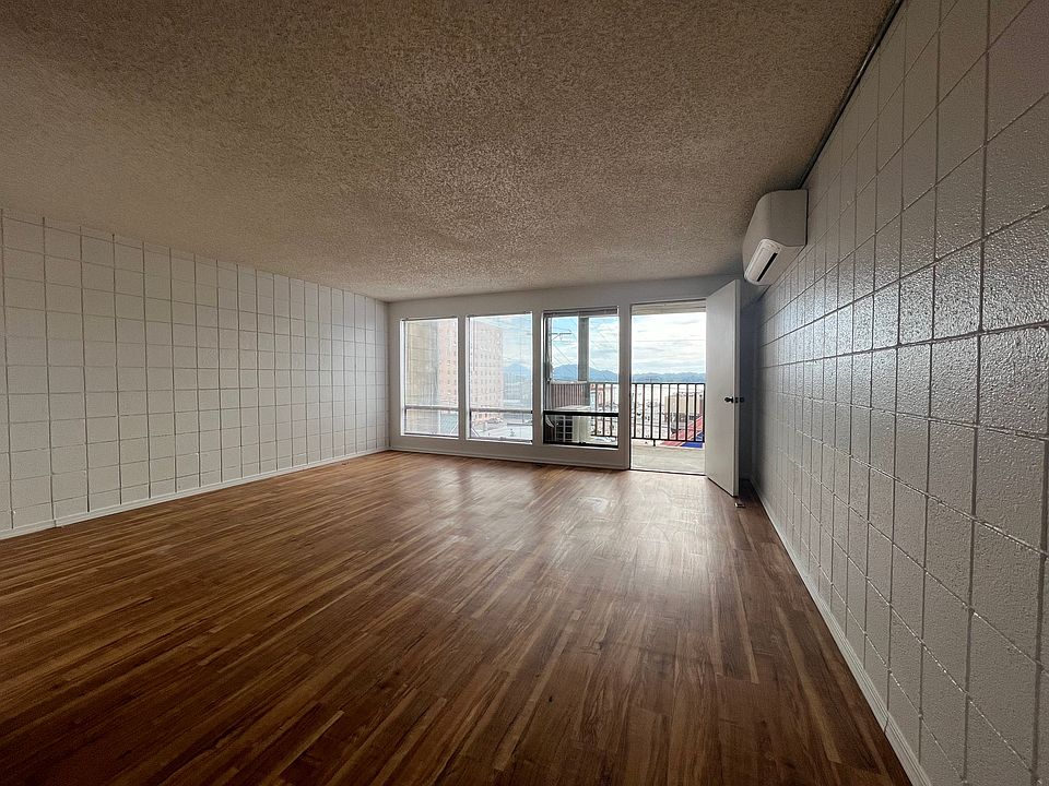 Large living area with big windows looking out to Tongass Narrows and doorway leading to your private deck.
