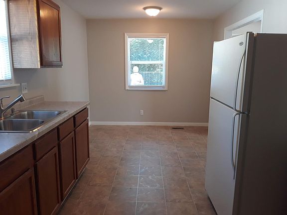 Kitchen showing eat in table area by window.