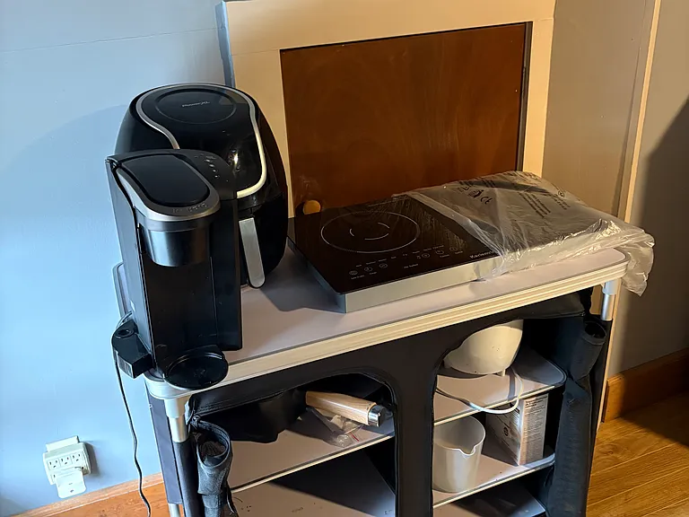 Kitchenette area with Air Fryer, Keurig, 2 Burner Cooktop and more.