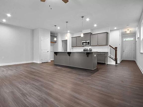 Large spacious family room, dining area and kitchen. Front door at end of hall on the right.
