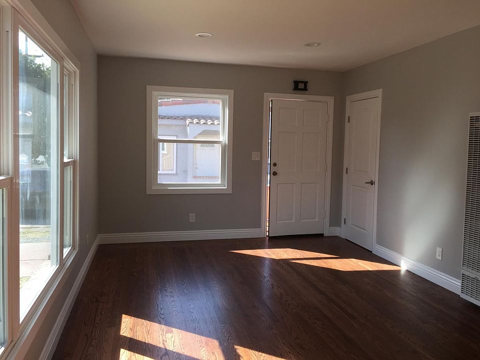 Living room with view of front door and entry closet