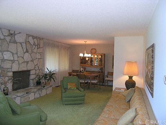 Lovely, large living room with PV Stone fireplace and formal dining area.