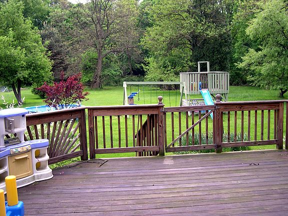 Deck overlooks park-like yard