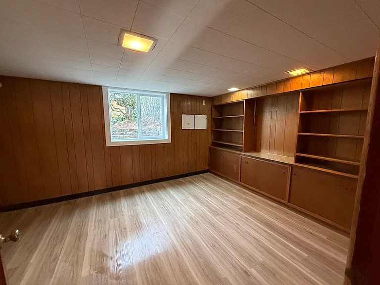 Unit B bedroom/or study with built in shelves, new vinyl wood floor and window