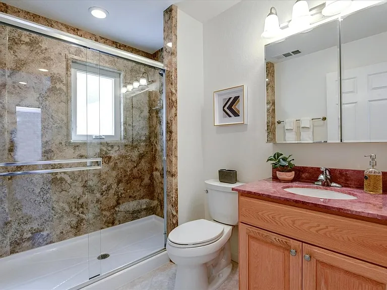 **Bathroom 1
A bright full bathroom with a walk-in glass shower, fresh towels, and plenty of counter space for your daily routine.