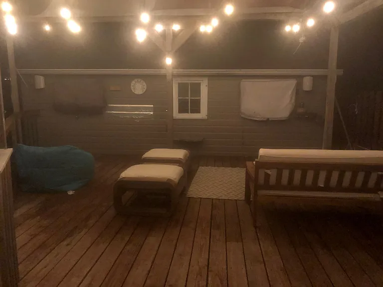Outdoor deck with Pergola, lighting, outdoor speakers, TV and lighting installed.