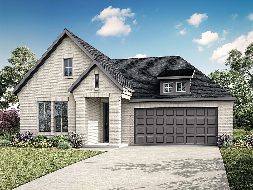 A charming two-story house with a gray exterior, a gabled roof, and a garage door stands in a well-m