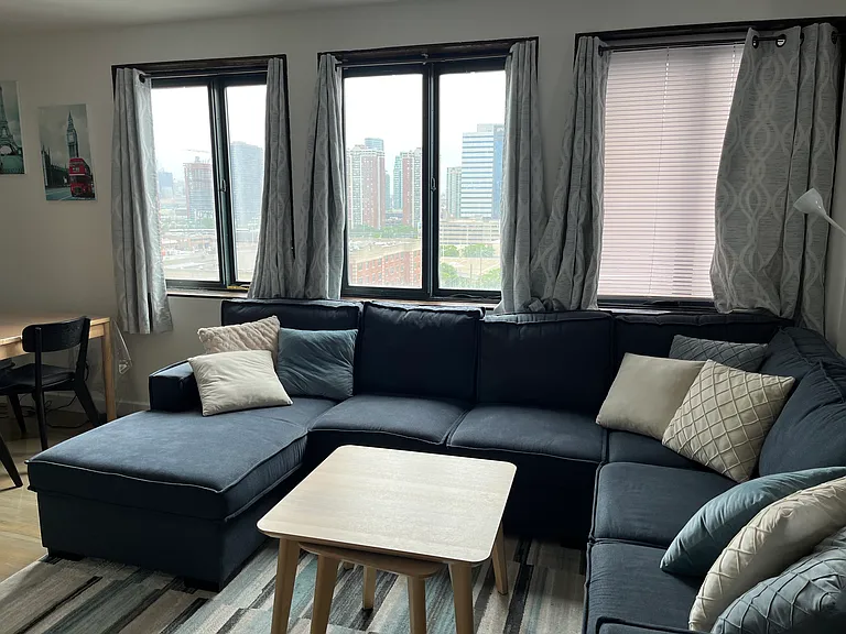 Living room with 3 large windows facing East (Manhattan)