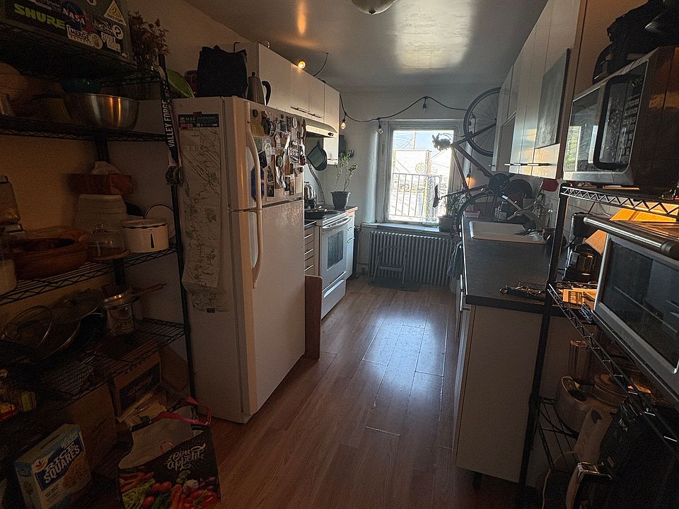 Long kitchen, with space for shelves or small kitchen table.