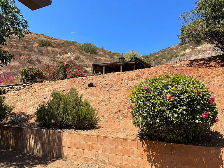 Large fenced backyard with deck on upper level