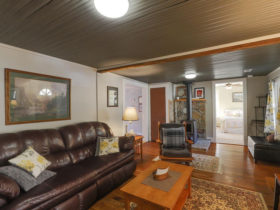 living room dimmable lighting , leather furniture, TV, and selection of dvd