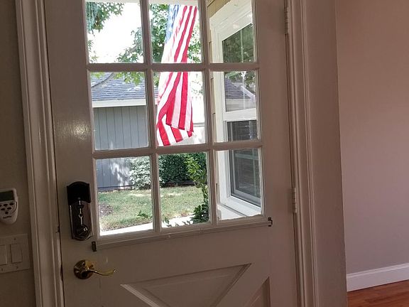 Front door with keyless entry leading to green belt