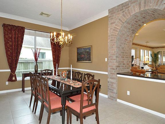 Striking brick arch compliments the formal dining room.