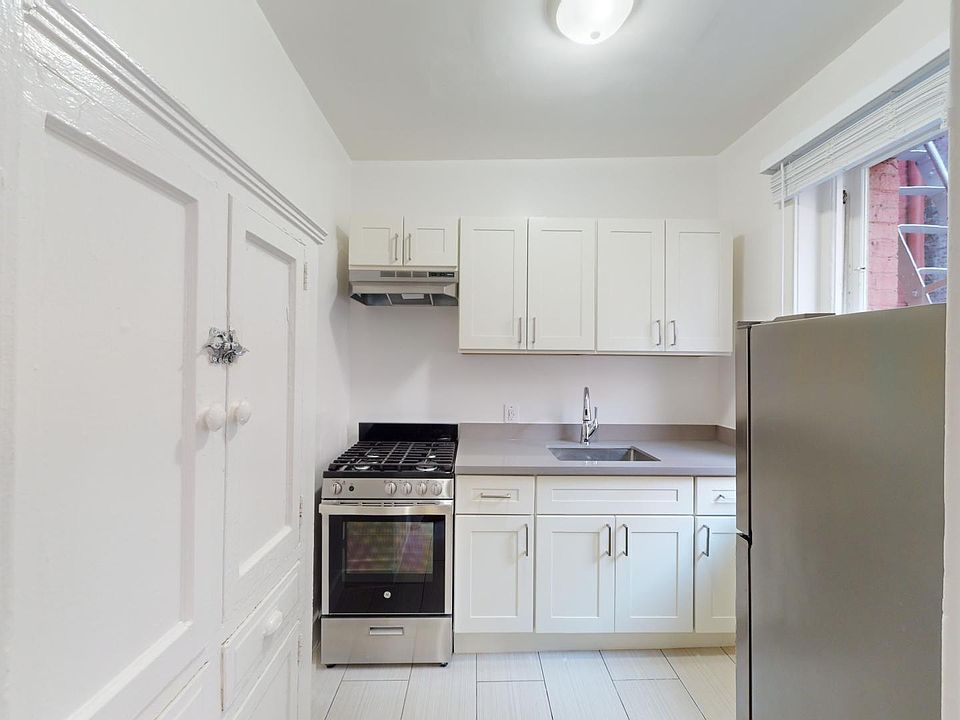 Kitchen featuring cabinets, stainless steel appliances, a gas stove, and a window providing natural light