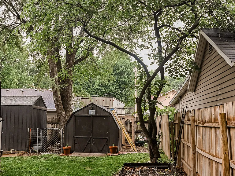 Two storage sheds and chicken coup behind sheds