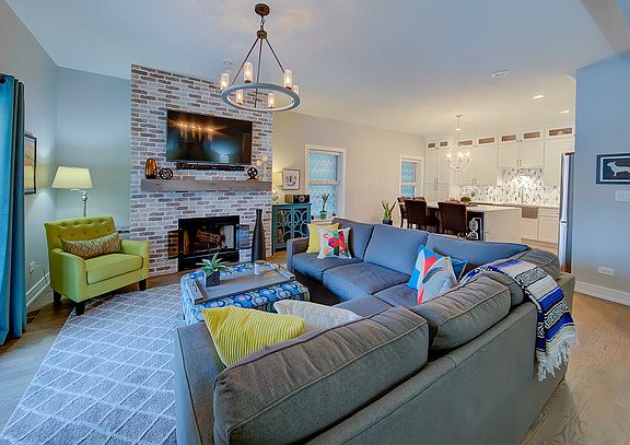 Former photo when furnished. Note the coloring is off on the fireplace and hardwood. The brick is GRAY/WHITE WASH and floors LIGHT GREIGE WOOD stain.