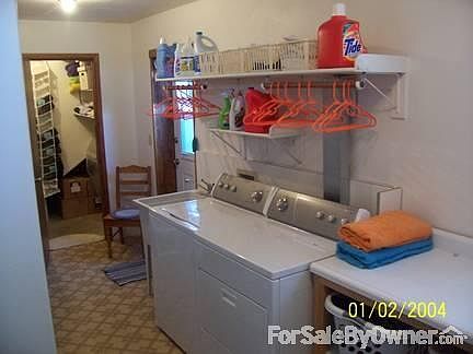 Laundry room
						:
						Large laundry room with folding table, shelves, and places to hang clothes.