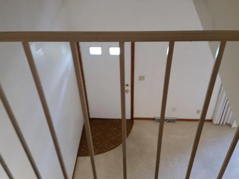 Balcony overlooking living room and front door