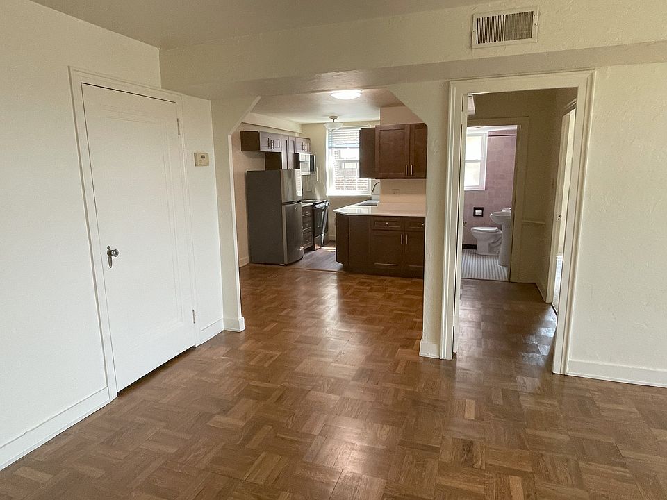 View from living room to dining room, kitchen, hall, and bathroom