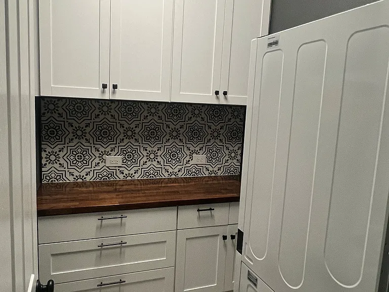 Laundry Room with wash tower and built-in cabinets.