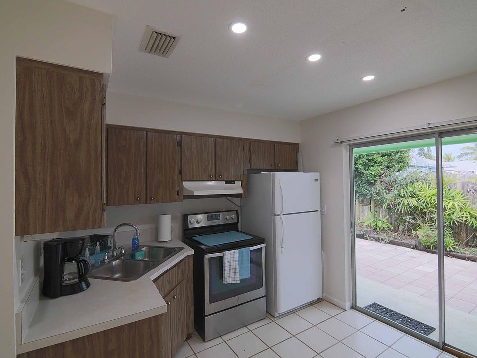 Open and bright with sliding glass doors leading to Private Fenced in landscaped patio.