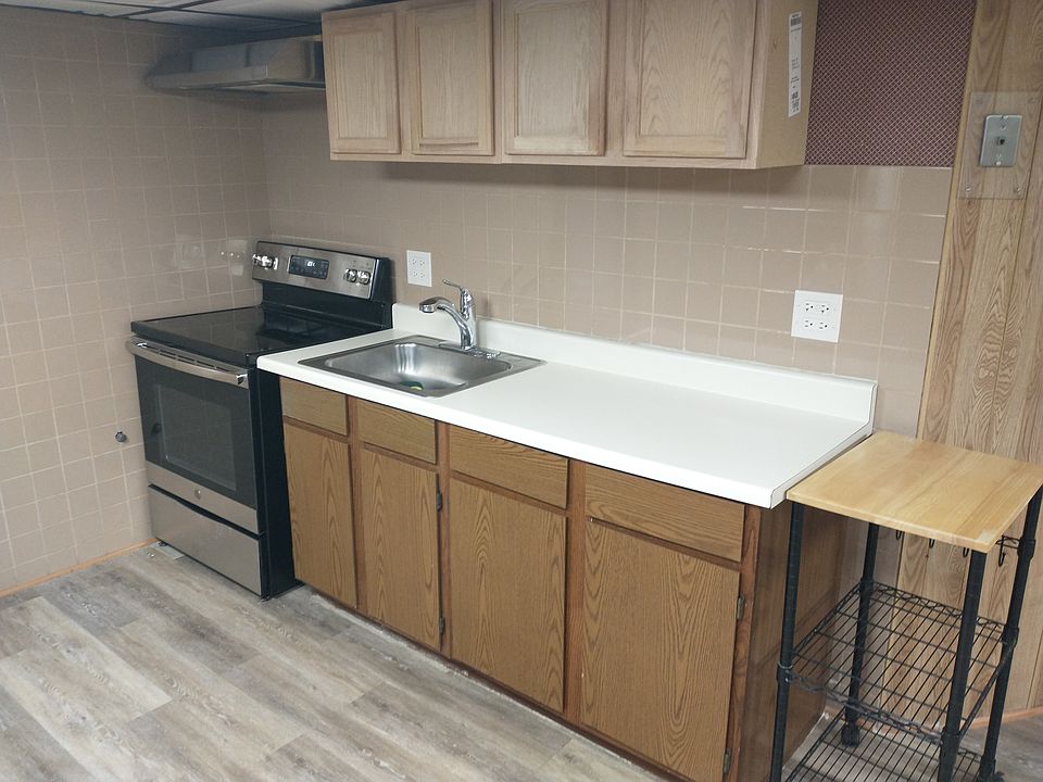 Kitchen area - range with overhead hood, cabinets, - space is large enough for a kitchen island and couple of seats