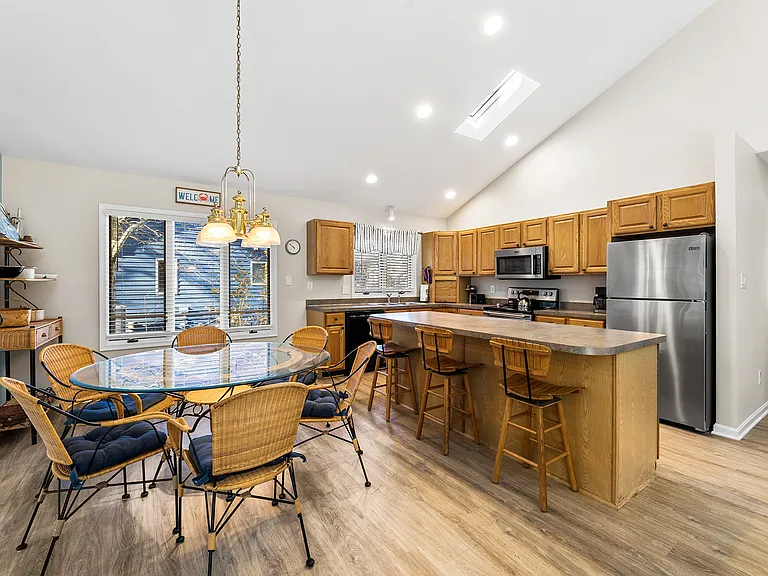 Bright kitchen and dining area with room for shared meals, family dinners, games, or remote work.