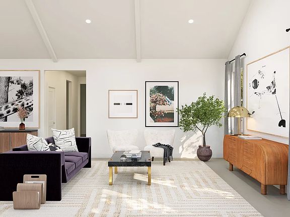 Great room with vaulted ceiling and white-painted ceiling beams