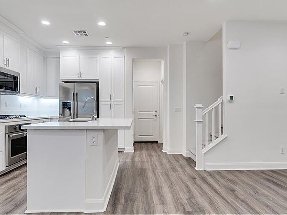 STAIRS LEAD TO 3 BD. 1 BA ON THE FIRST FLOOR. DOOR LEADS TO 2 CAR GARAGE