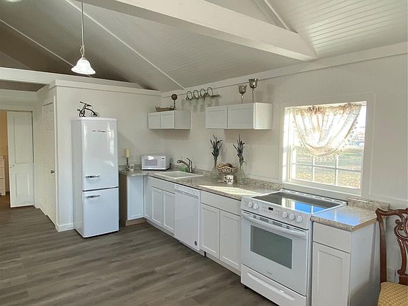 Kitchen includes the fridge and a great view out the window over the cooktop.