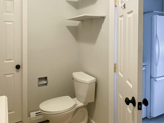 Shared laundry room through door on the left.
