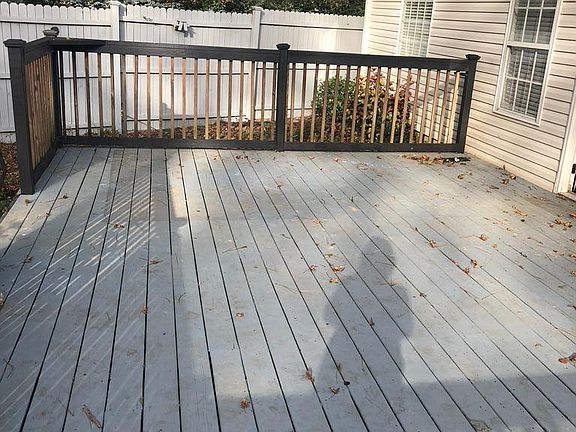 large deck in fenced with back yard