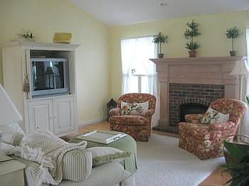 Formal living room includes a gas burning fireplace