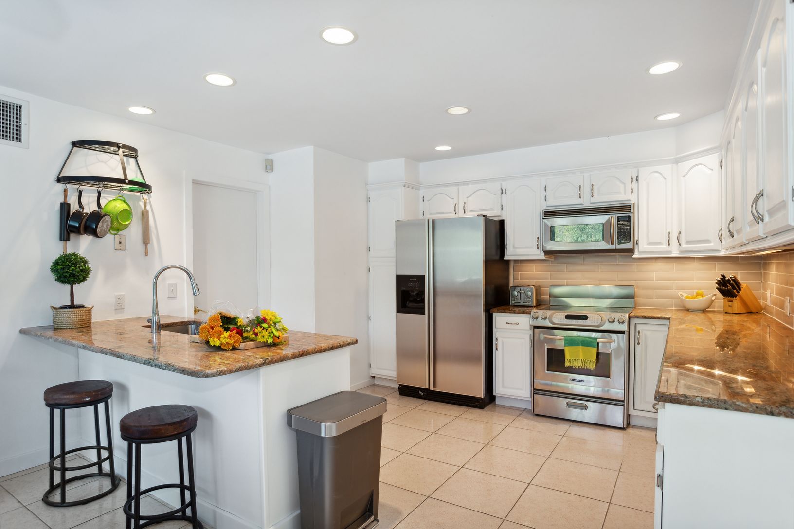  Kitchen is light bright and hosts sliders to the pool deck