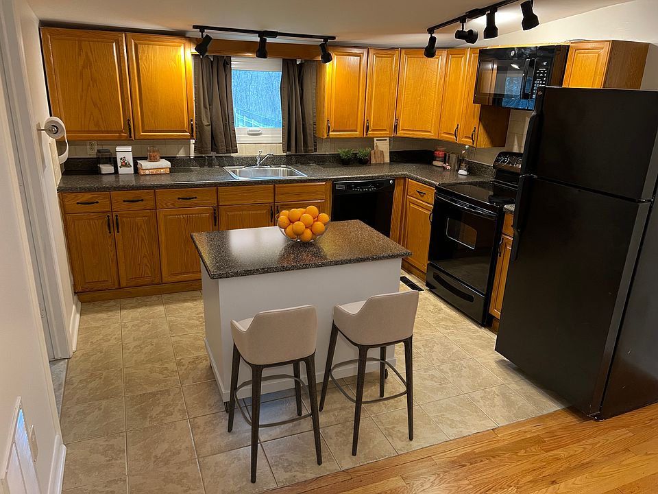 Eait-in Kitchen features plenty of cabinets, track lighting, newer appliances , ceramic tile flooring, (ample room for center island as shown in staged photo).