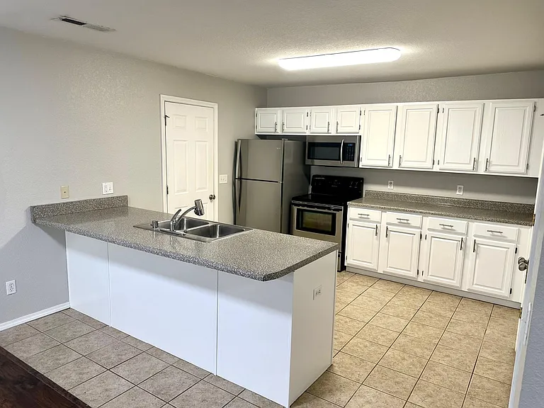 Kitchen island with door leading into the two car garage