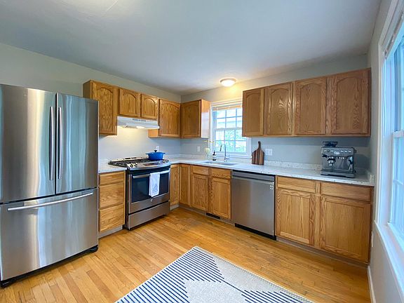 This kitchen boasts new custom granite countertops, French Door Refrigerator, high BTU burners, and dishwasher.