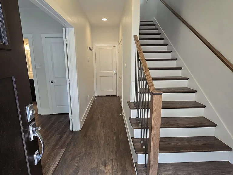 garage entrance, laundry closet, and bedroom with full bath on ground floor