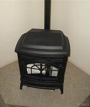 Thermostated controlled Quadra-Fire Pellet Stove in Living Room