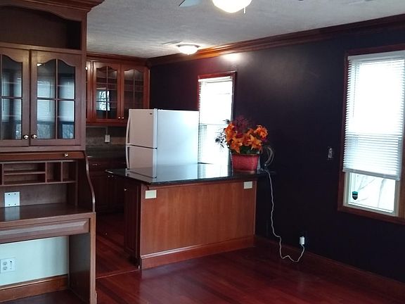 Writing desk and kitchen island at kitchen / living room edge.