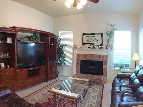 Second Living Area w/ view of backyard & ceiling fan