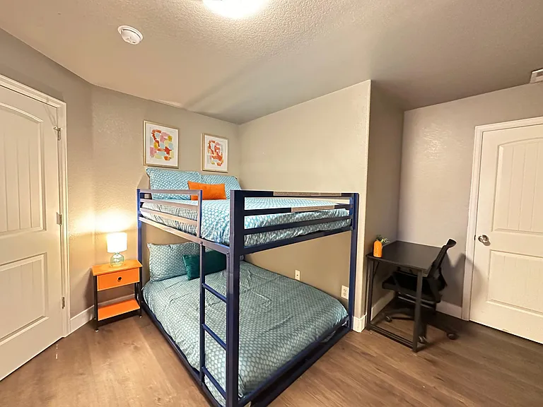 Our spacious room is perfect for groups, featuring a double-sized bunk bed, an additional double bed, and a smart TV for everyone's enjoyment.